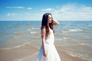 Fototapeta na wymiar Young beautiful brunette woman in white dress