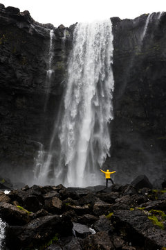 Hiker at Fossa waterfall, Streymoy island, Faroe Islands, Denmark