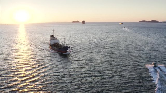 Aerial panoramic view of the ship and motorboat floating along strait