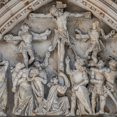 Crucifixion of Christ scene at major entrance portal of Saint Vitus Cathedral in Prague, Czech Republic, details, closeup