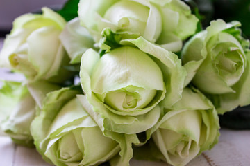 Wedding bouquet of white flowers on a light background. Wedding flowers in nature. Candles. Wedding background. Beautiful wedding bouquet. Preparation for the wedding ceremony. White wedding flowers. 