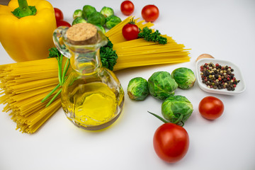 Food background. isolate Various culinary ingredients with spaghetti and vegetables and butter. Top view with copy space.