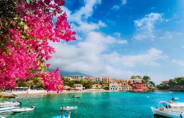 Cercles muraux Plage tropicale Beautiful Assos village scenery framed with branch of magenta blossom fuchsia flower. Summer vacation concept