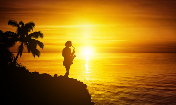saxophonist woman at tropical sunset