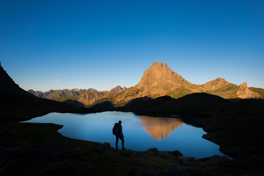 Taking in the view of Midi d'Ossau beyond Lac Gentau beside the GR10 trekking route in the French Pyrenees, Pyrenees Atlantiques, France