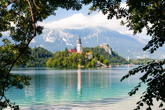 Tiny island with a church, a castle on a crag, and mountain views, Lake Bled, Slovenia