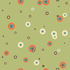 Festive colorful dotted seamless pattern. Random polka dot, rings background. Orange, blue, yellow, brown circles on green. Spotted abstract seamless pattern. Vector illustration.