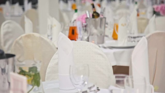 Festive Interior: White Room with Dining Tables Decorated for Wedding Banquet Celebration in Hall