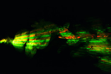 Laser ray green red yellow in the dark