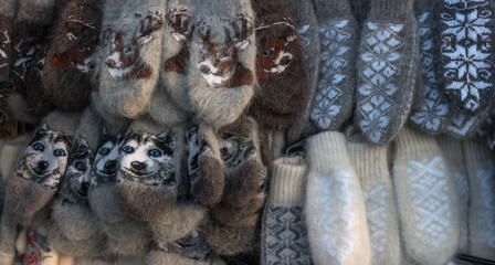 Mittens on the winter Christmas market. Multi-colored knitted woolen mittens.