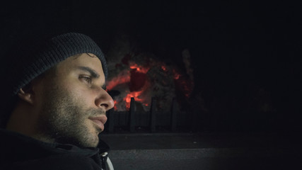 portrait young man in front of a fireplace