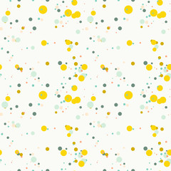 Bright yellow, blue, green, orange messy dots on white background. Festive seamless pattern with round shapes. Grunge dotted texture for wrapping paper, web. Vector illustration.
