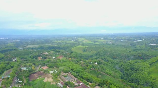 AERIAL: extremely high and straight push over the precious Panaca park in Quidio, Colombia, that's been surrounded by coffee plantations.