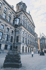 Obraz premium Street corner, touristic square, iconic house in Amsterdam, Holland. Ancient style.