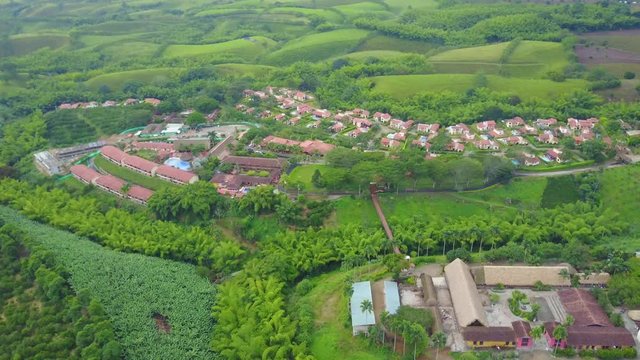 AERIAL: tracking around a bridge over a valley within the precious Panaca park in Quidio, Colombia, that's been surrounded by coffee plantations.