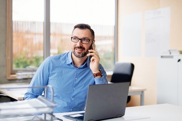 middle aged handsome man working on laptop computer