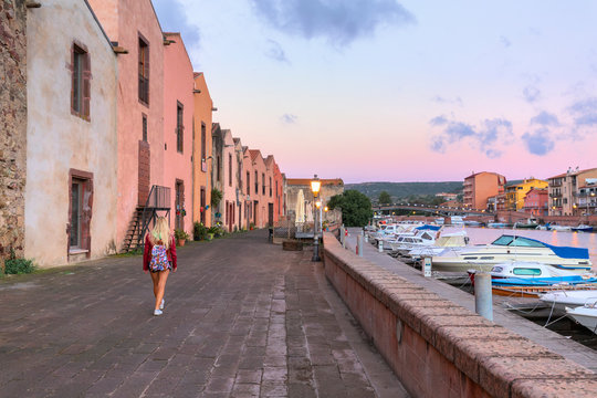 A girl walks at sunrise, Bosa, Oristano province, Sardinia, Mediterranean