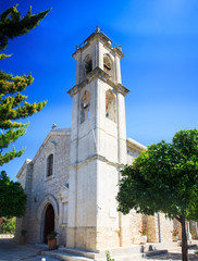 Fototapeta na wymiar A large white the holy cross church with a bell tower in the Lefkara village mountains Troodos on the island of Cyprus