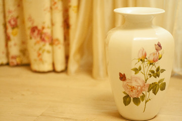 flowers in vase on a wooden background