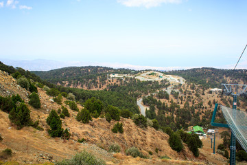 Fototapeta na wymiar Beautiful scenic view of the panorama of green hills and hills of mountains from the Trodos mountain on the island of Cyprus