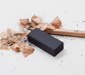 Pencils and black eraser, debris on grey sketch notepad background