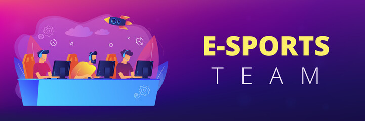 Professional gamers team with headsets at the table at computer playinng video games. E-sports team, group of gamers, pro gamers team concept. Header or footer banner template with copy space.