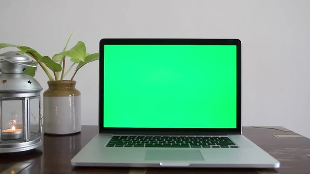 A laptop with a green screen which can be removed to place any content as per the requirement.