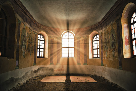 Old deserted church interior with sunlight shining through the window