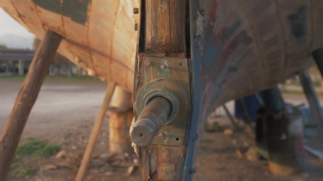 Beautiful old rustic sapele timber planked boat stern gimbal shot
