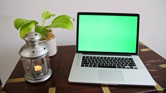 A laptop with a green screen which can be removed to place any content as per the requirement.