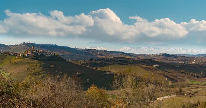 Hyper time lapse of Langhe vineyards panorama, Castiglione Falletto and La Morra, Unesco Site, Piedmont, North Italy, alps mountains background.