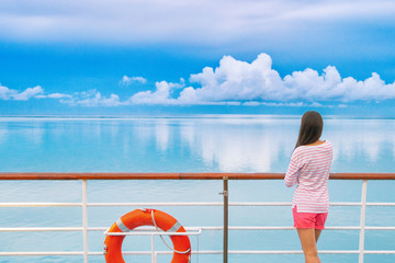 Cruise ship luxury travel woman on deck looking away in Tahiti. Serene still ocean water landscape....