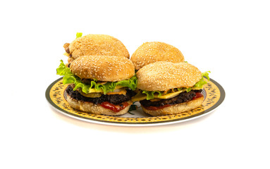 Four Hamburgers with cheese and salad on a plate