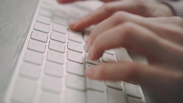 Hands typing on keyboard. Close up of female hands typing keyboard buttons