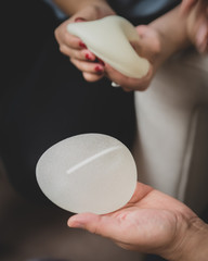 Plastic surgeon and patient discuss choice of breast implants after mastectomy or for breast...