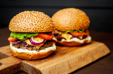 Two Delicious Fresh Homemade Burger on a Cutting Board