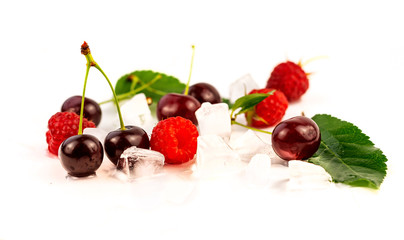 Raspberry, cherries with green leaves and particles of ice