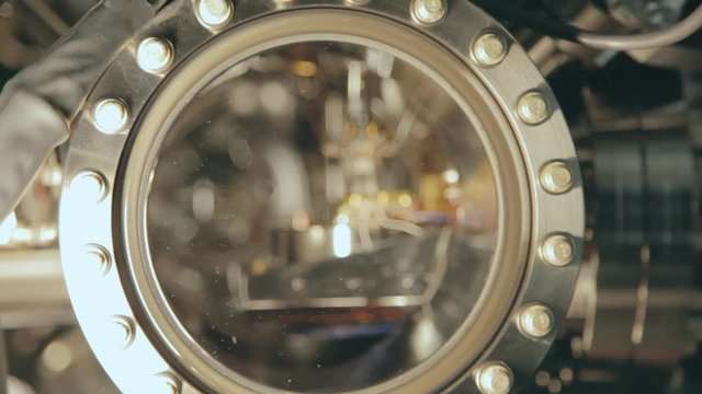 Close up view of a lens in a piece of scientific equipment found in a university laboratory facility. Modern equipment provides the best hands on education for students. FOCUS PULL.