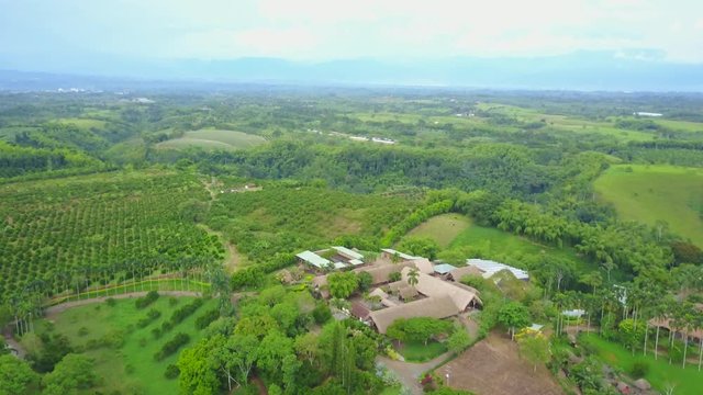 AERIAL: pushing and tilting down towards the coffee plantation near the precious Panaca park in Quidio, Colombia, that's been surrounded by coffee plantations.