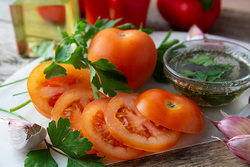 Fresh red tomatoes with spices and olive oil.