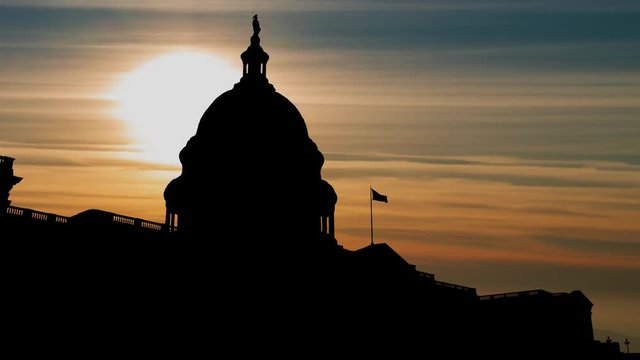 Washington DC: The United States Capitol Building in Silhouette Red Sun and Clouds, USA 