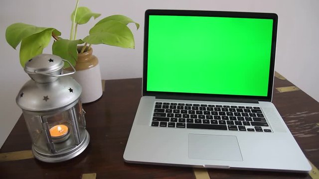 A laptop with a green screen which can be removed to place any content as per the requirement.