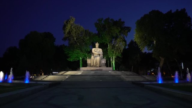 unidentified tourist visiting the statue of Amir Timur at night, Samarkand, Uzbekistan. Slow motion video. 