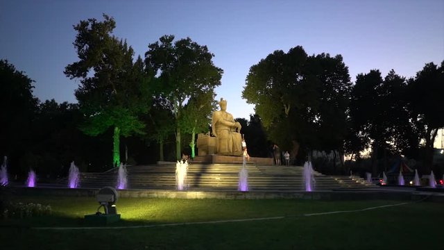 unidentified tourist visiting the statue of Amir Timur at night, Samarkand, Uzbekistan. Slow motion video. 