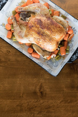 Roasted Chicken with Vegetables on a wooden table background