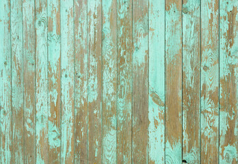 Wooden background with peeling green paint
