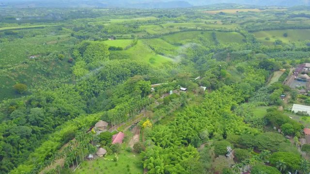 AERIAL: angled rotation around a mountainous portion of the precious Panaca park in Quidio, Colombia, that's been surrounded by coffee plantations.