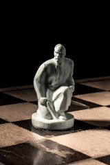 Chess board. Beautiful white handmade pawn
