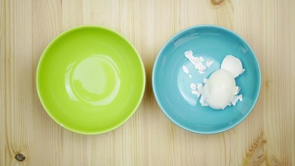 Hard boiled white egg is peeled and cut in four by itself. Stop motion animation.View from above - Powered by Adobe