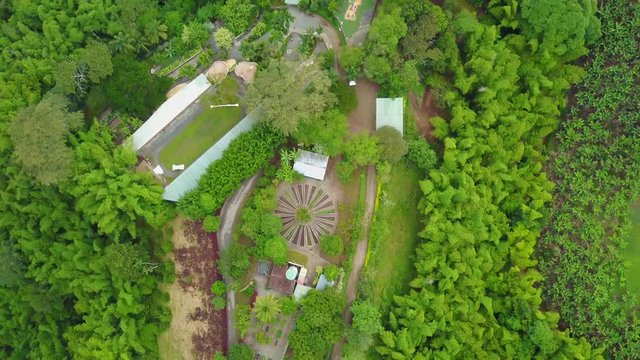AERIAL: twisting and lifting up to reveal the precious Panaca park in Quidio, Colombia, that's been surrounded by coffee plantations.